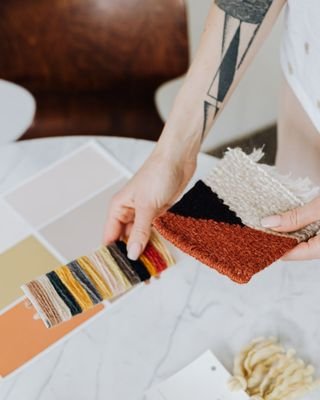 Material and colour samples being compared by hand